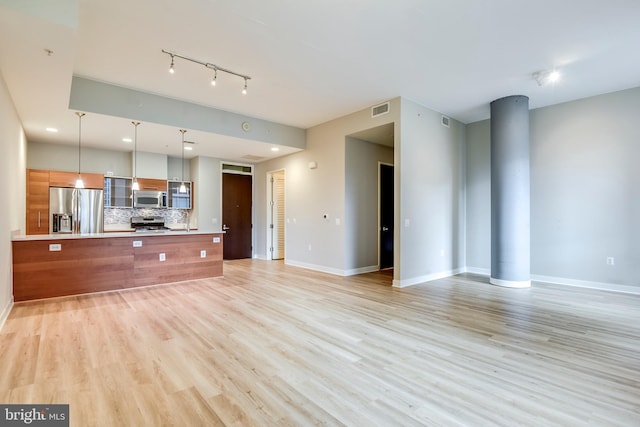 unfurnished living room with recessed lighting, visible vents, light wood-style flooring, and baseboards