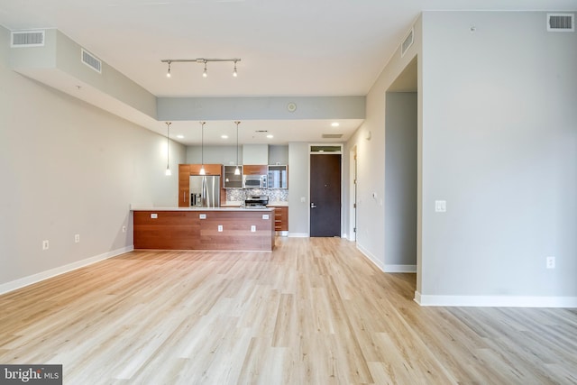 unfurnished living room with visible vents, baseboards, and light wood-style flooring