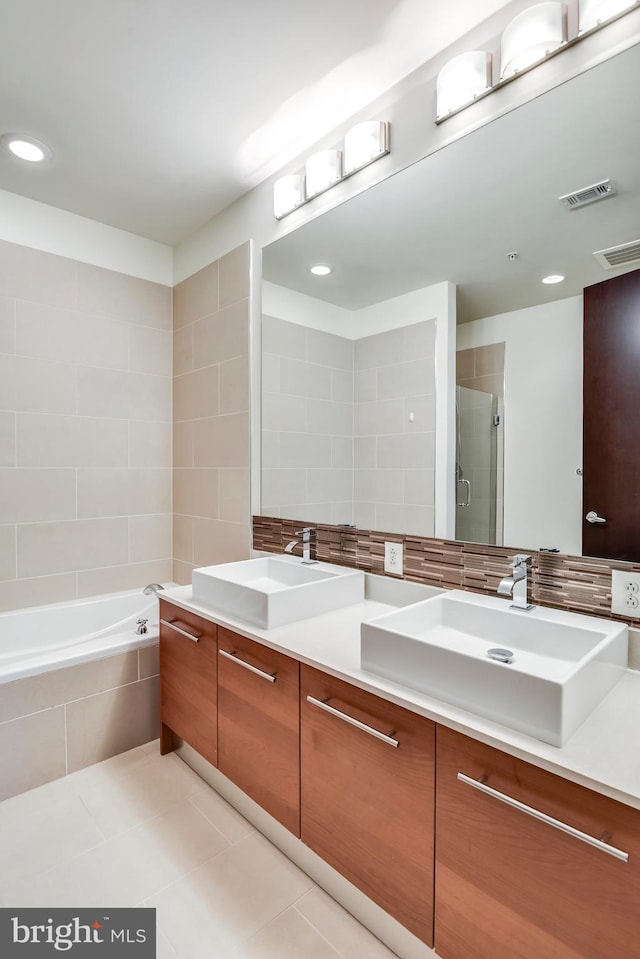 bathroom featuring a sink, visible vents, a stall shower, and double vanity