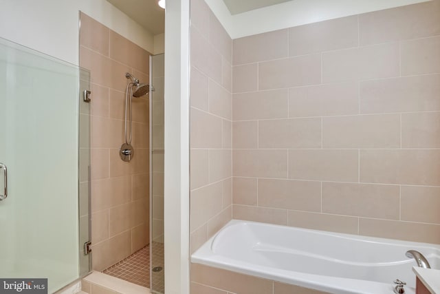 bathroom with a garden tub and a stall shower