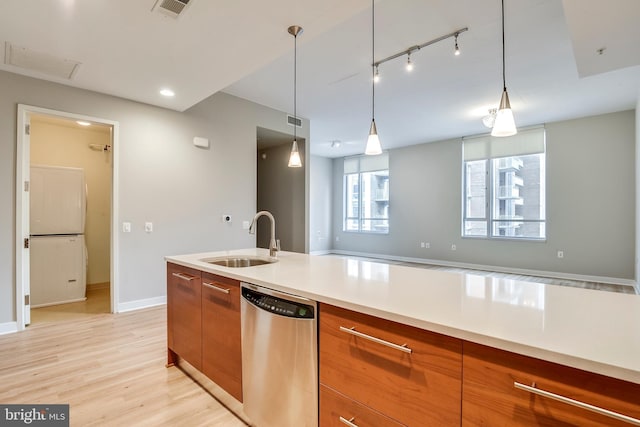 kitchen featuring visible vents, a sink, dishwasher, modern cabinets, and brown cabinets