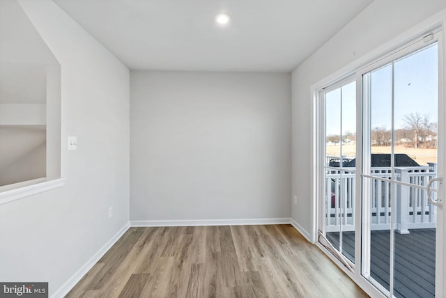 unfurnished room featuring wood finished floors and baseboards