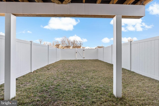 view of yard featuring a fenced backyard and a gate