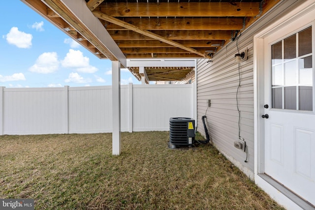 view of yard featuring cooling unit and fence