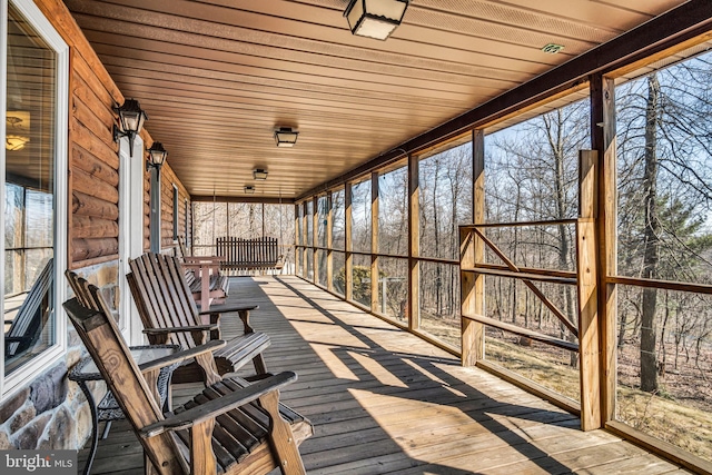 unfurnished sunroom with wood ceiling