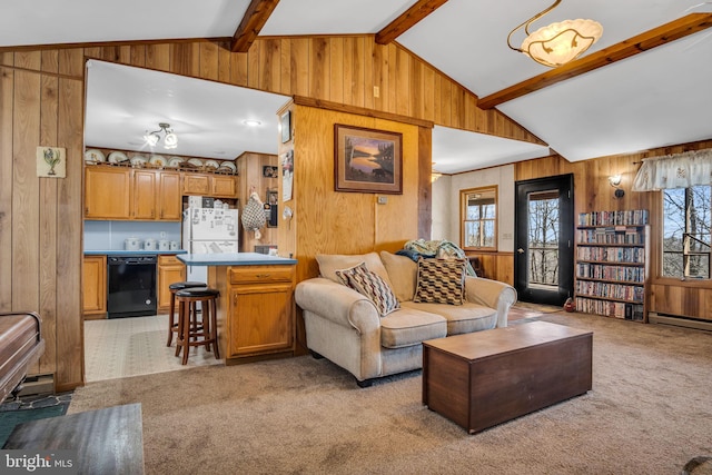 living area with wooden walls, vaulted ceiling with beams, and light colored carpet