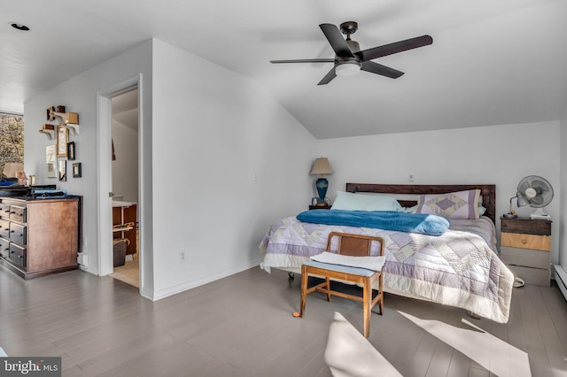 bedroom featuring ceiling fan, baseboards, wood finished floors, and vaulted ceiling