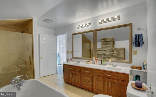 bathroom with double vanity, a soaking tub, a stall shower, and a sink