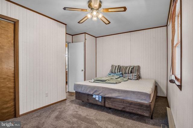 bedroom with ornamental molding, a ceiling fan, and carpet floors