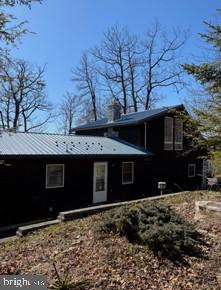 back of property featuring metal roof