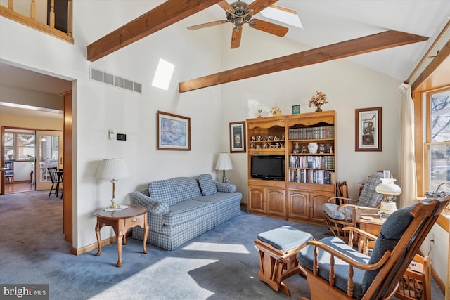 carpeted living room with visible vents, beam ceiling, high vaulted ceiling, a skylight, and ceiling fan