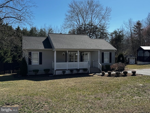 view of front of house featuring a porch, a front yard, and a shingled roof