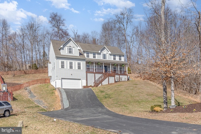 view of front facade with a front lawn, stairs, covered porch, driveway, and an attached garage