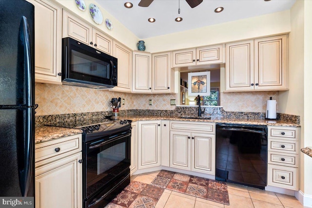 kitchen featuring a sink, cream cabinets, black appliances, and light tile patterned flooring