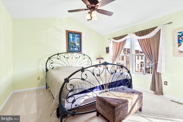 carpeted bedroom featuring visible vents, baseboards, lofted ceiling, and a ceiling fan