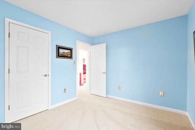 unfurnished bedroom with baseboards and carpet flooring