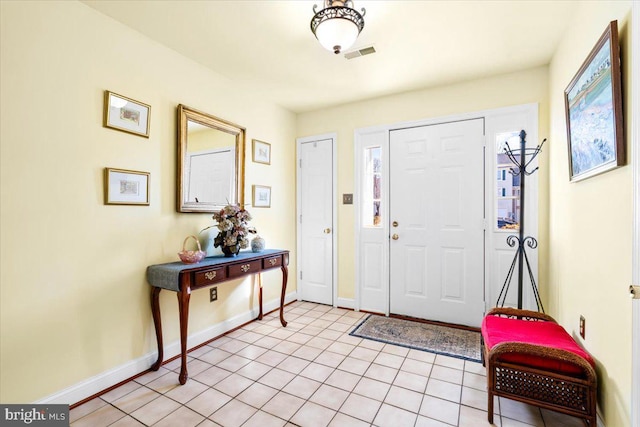 entryway featuring light tile patterned floors, visible vents, and baseboards