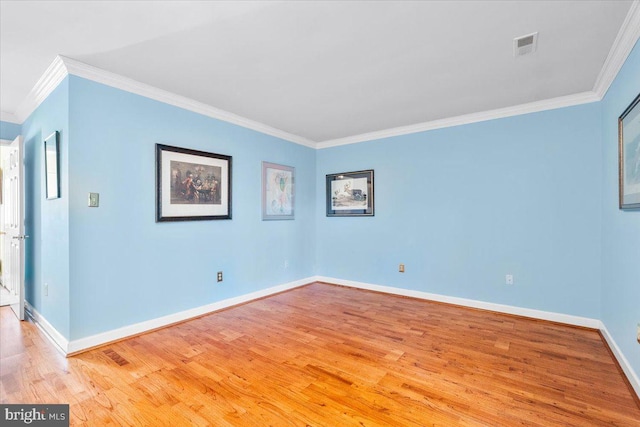 unfurnished room featuring visible vents, baseboards, crown molding, and light wood-style floors