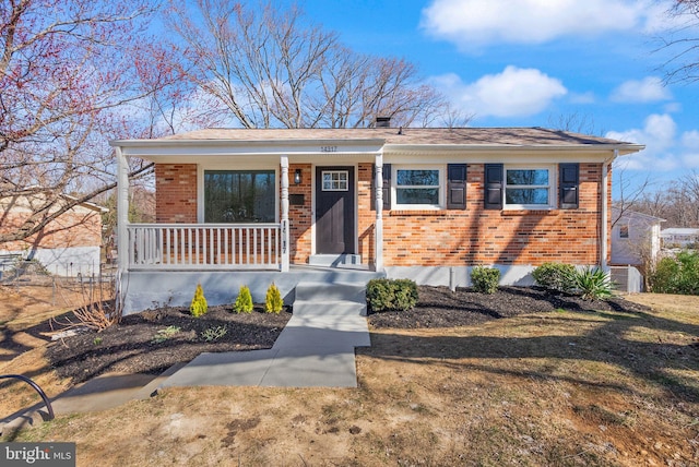 view of front of property featuring covered porch and brick siding