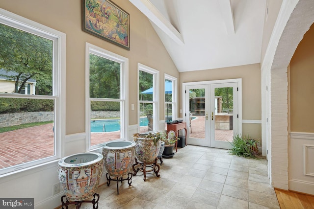 sunroom featuring french doors and lofted ceiling