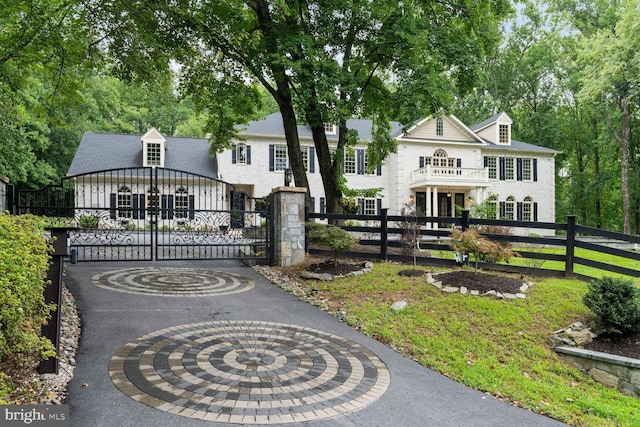 view of front of property with a fenced front yard and a gate