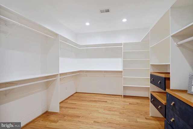 walk in closet featuring light wood finished floors and visible vents