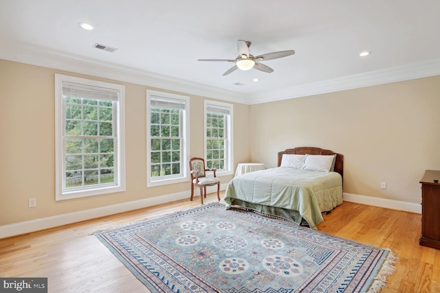 bedroom with visible vents, light wood-style flooring, recessed lighting, crown molding, and baseboards