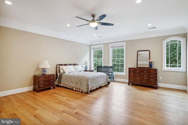 bedroom with crown molding, baseboards, visible vents, and light wood-type flooring