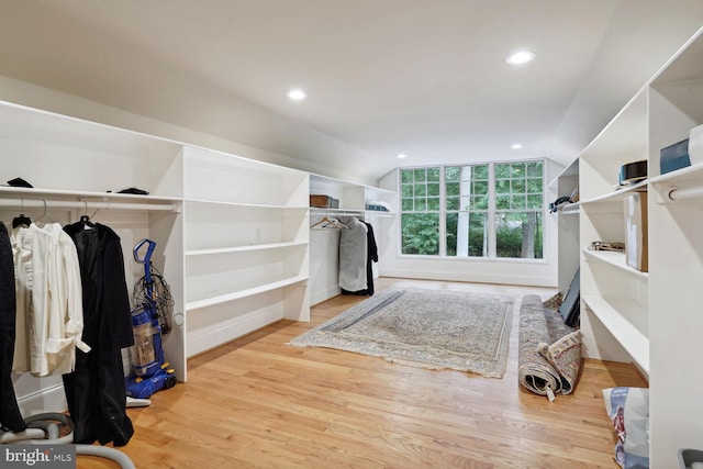 walk in closet featuring vaulted ceiling and wood finished floors