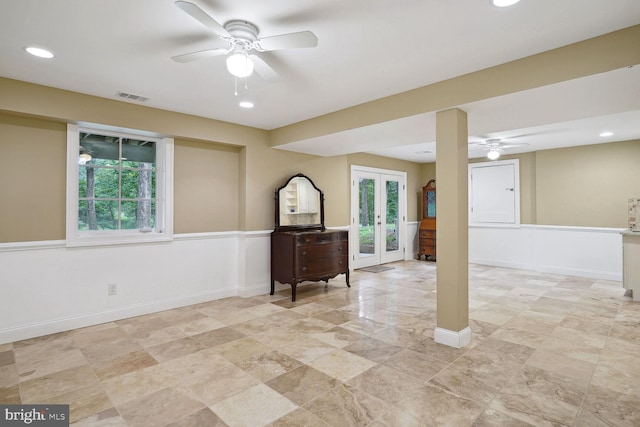 below grade area with visible vents, baseboards, recessed lighting, french doors, and a ceiling fan