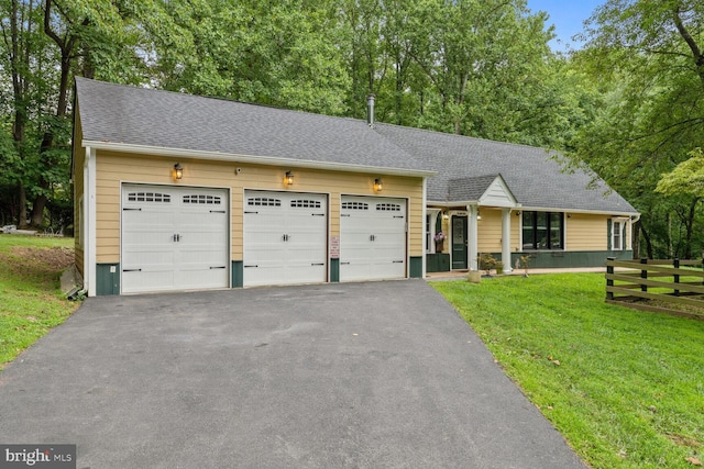 single story home featuring driveway, a front lawn, fence, a shingled roof, and a garage