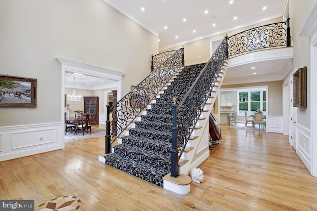 entrance foyer featuring stairway, ornamental molding, and wood finished floors