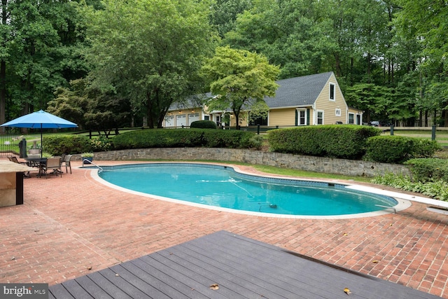 view of pool featuring a patio area, a fenced in pool, and fence