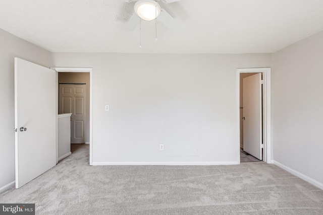 unfurnished bedroom with baseboards, carpet, and a ceiling fan