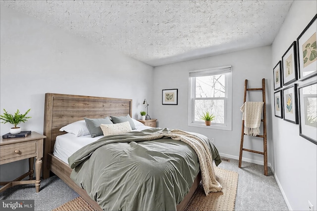 bedroom with baseboards, carpet, and a textured ceiling