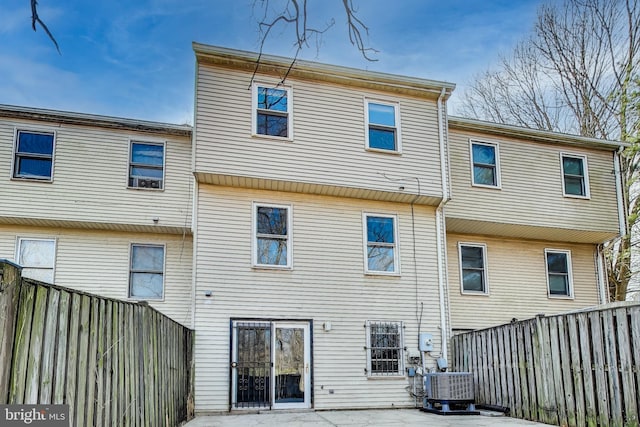 back of property featuring central AC unit, a patio, and a fenced backyard