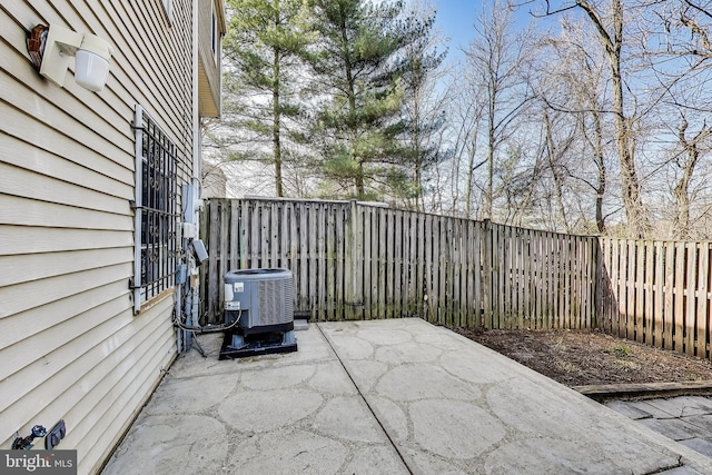 view of patio with central air condition unit and a fenced backyard