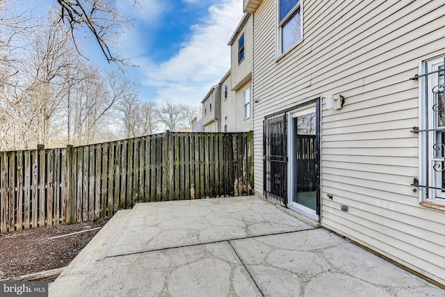 view of patio featuring fence