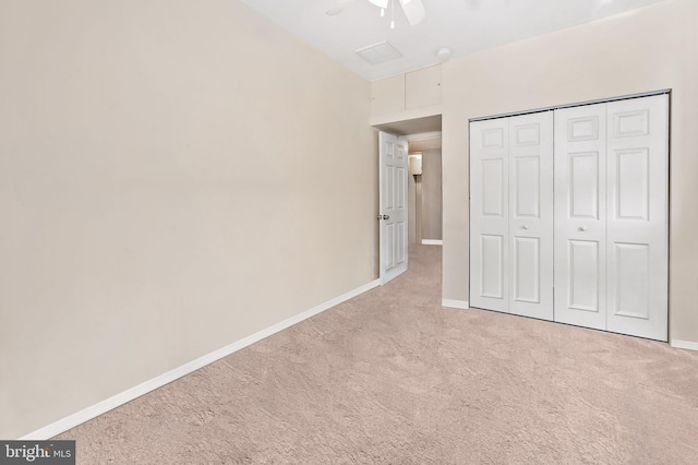 unfurnished bedroom featuring carpet flooring, baseboards, a closet, and ceiling fan