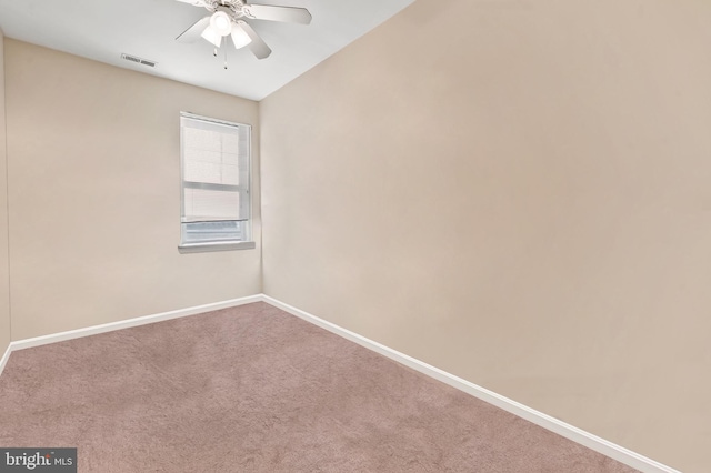 carpeted empty room featuring a ceiling fan, baseboards, and visible vents