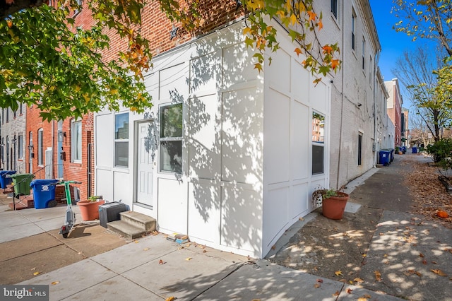 view of side of home with brick siding and entry steps