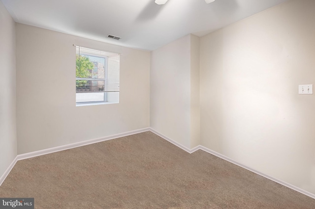 empty room with visible vents, baseboards, and carpet flooring