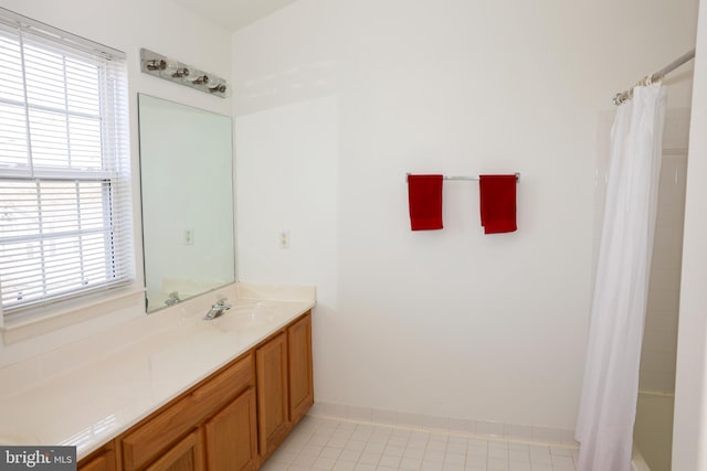 full bathroom with baseboards, vanity, and tile patterned flooring