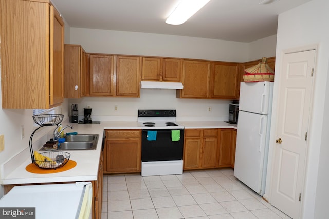 kitchen with electric range, freestanding refrigerator, a sink, light countertops, and under cabinet range hood