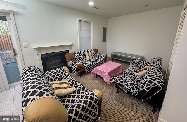 interior space featuring visible vents, baseboards, electric panel, recessed lighting, and a glass covered fireplace