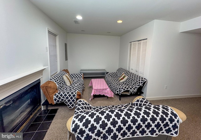 interior space with visible vents, a fireplace with flush hearth, recessed lighting, a closet, and baseboards