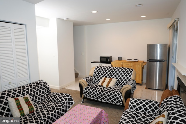 living room with light tile patterned floors, recessed lighting, and baseboards