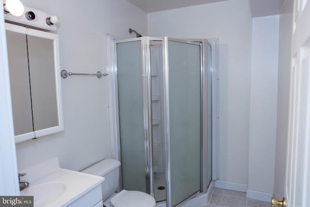 full bath with tile patterned flooring, toilet, a stall shower, and vanity