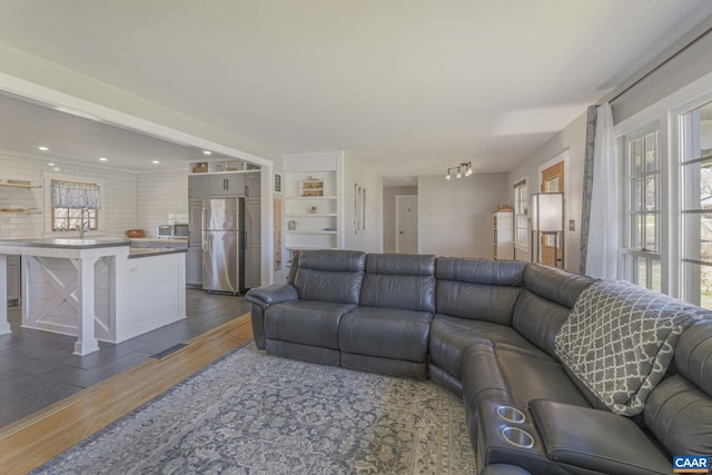 living area with recessed lighting and wood finished floors