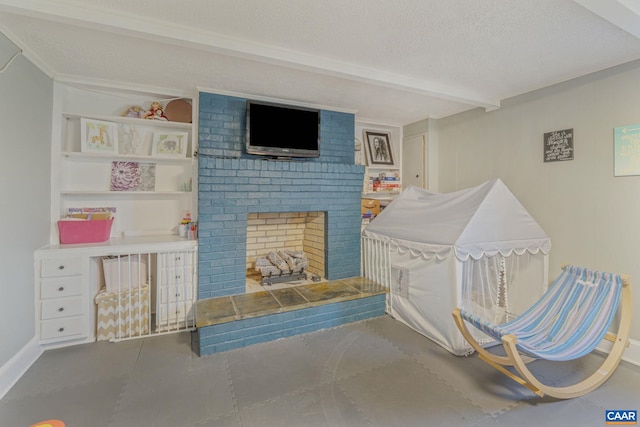 interior space with beamed ceiling, a fireplace, baseboards, and a textured ceiling